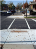 A corner of Columbia Street with new paving, ramps, and crosswalk paint