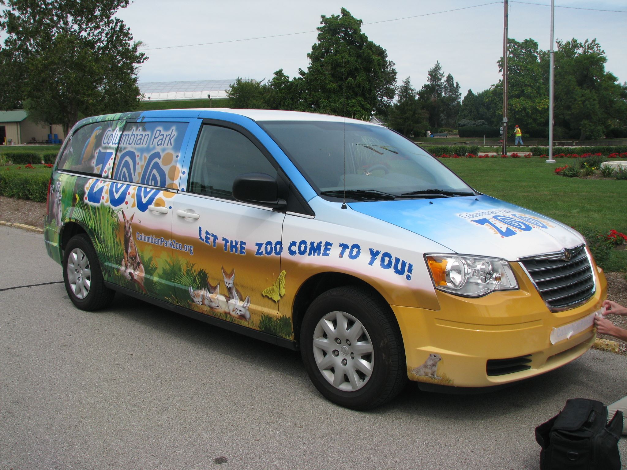 Mini-van with a decorative graphics wrap depicting zoo animals