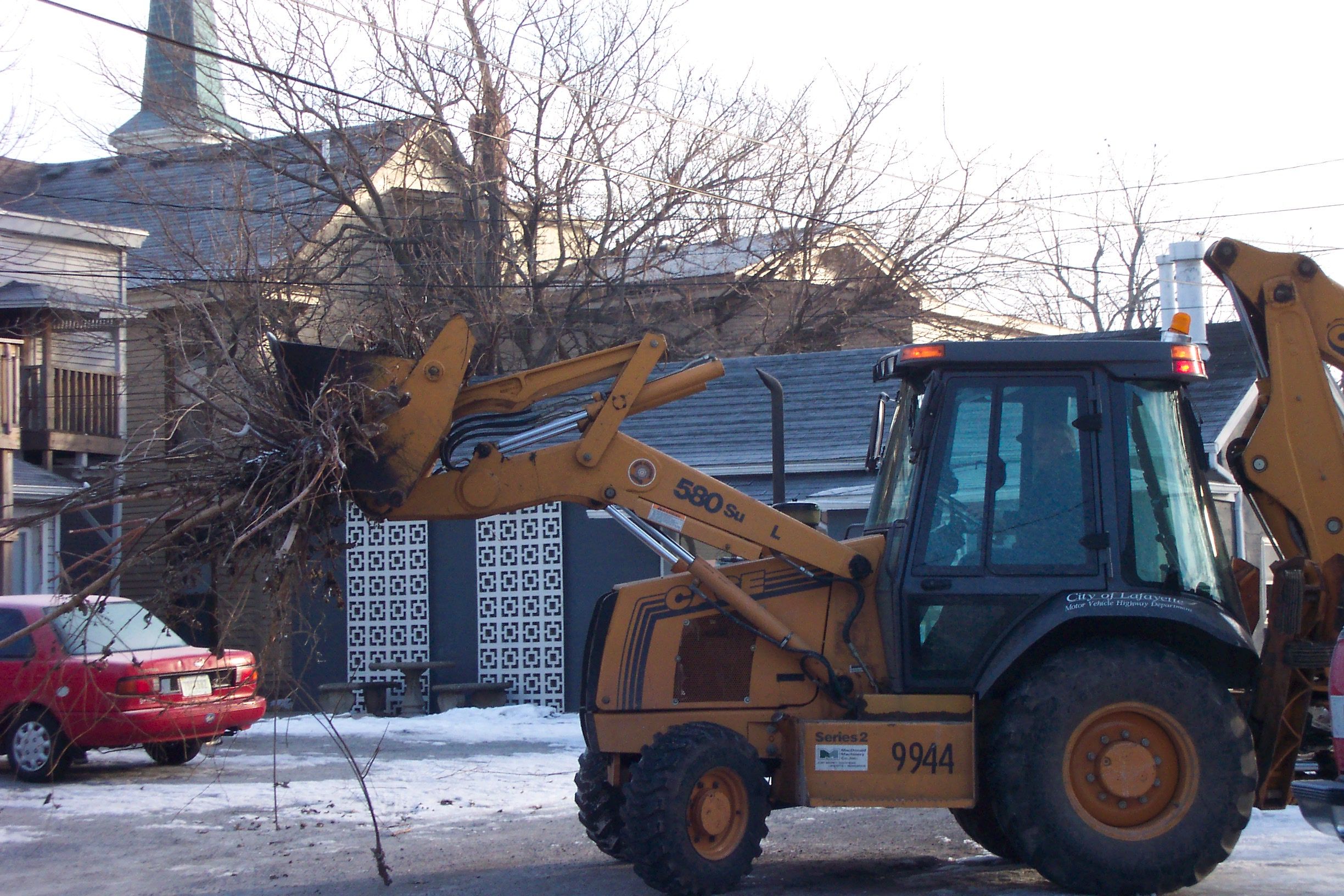 Bucket Machine Collection Yard Waste in Front of Residency Driveway
