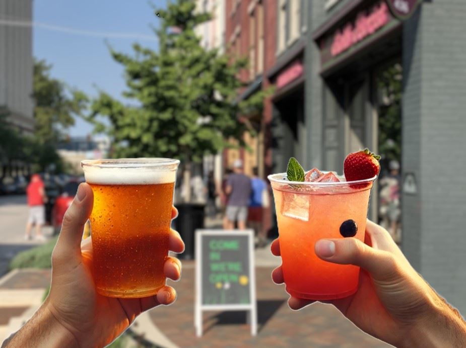 hands holding drinks on Downtown Lafayette street